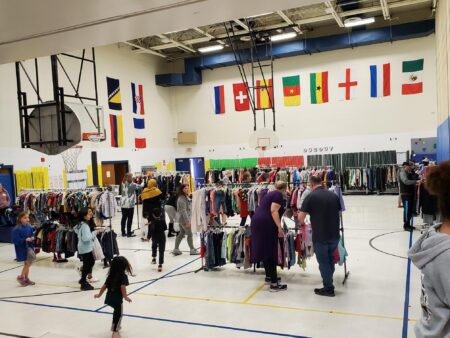 Families in need peruse gifted clothing. Photo courtesy of Frank Walton private archive