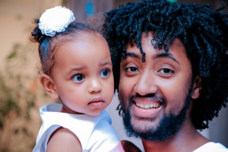 Photo of father holder daughter by Gift Habeshaw on Unsplash.