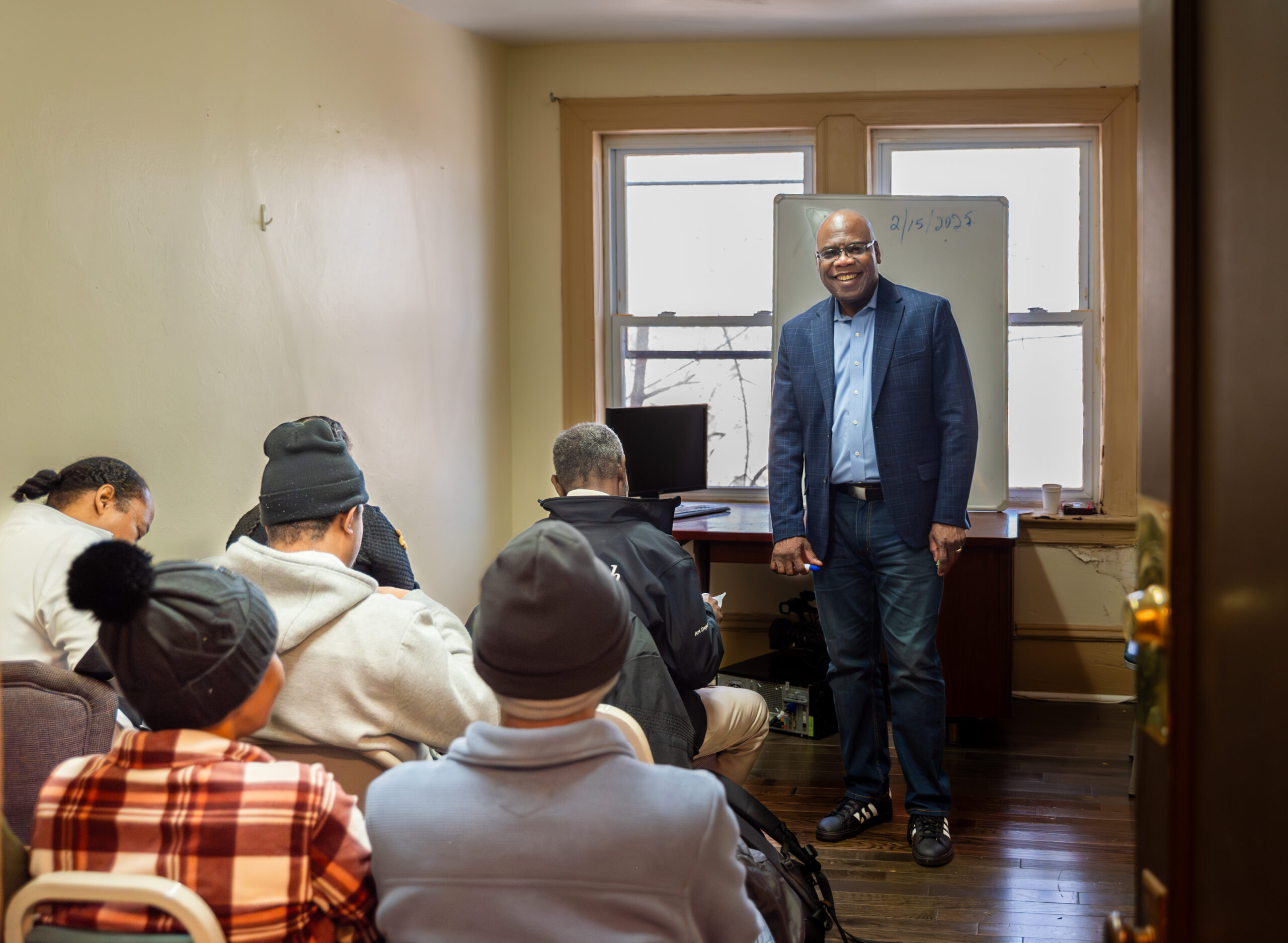 Photo of Rev. Dr. Older Azard teaching English to class of Haitian students